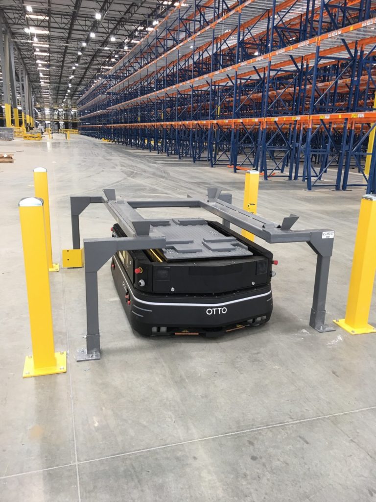 Robot docking station and support stand in a warehouse